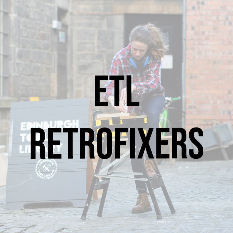 Member of Edinburgh Tool Library Retrofixers working outside on a portable workbench